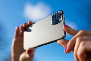 Person,Holding,In,Hands,Modern,Smartphone