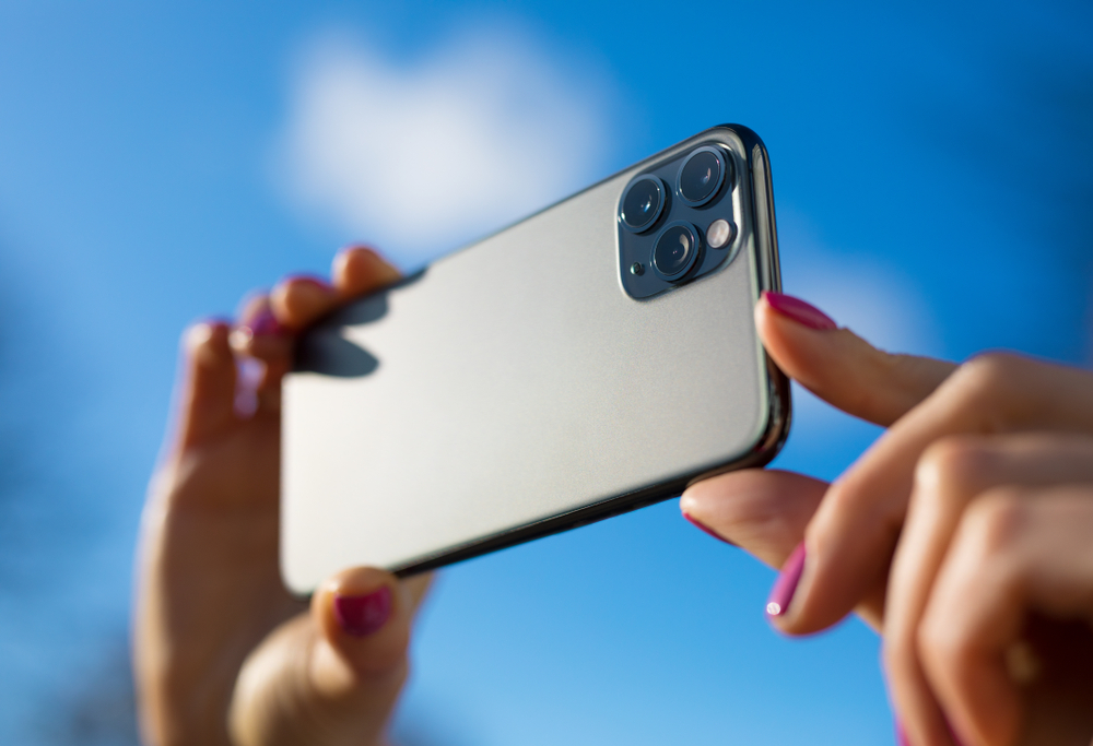 Person,Holding,In,Hands,Modern,Smartphone