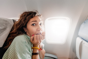 Woman,With,Aerophobia,Is,Afraid,To,Fly,On,An,Airplane